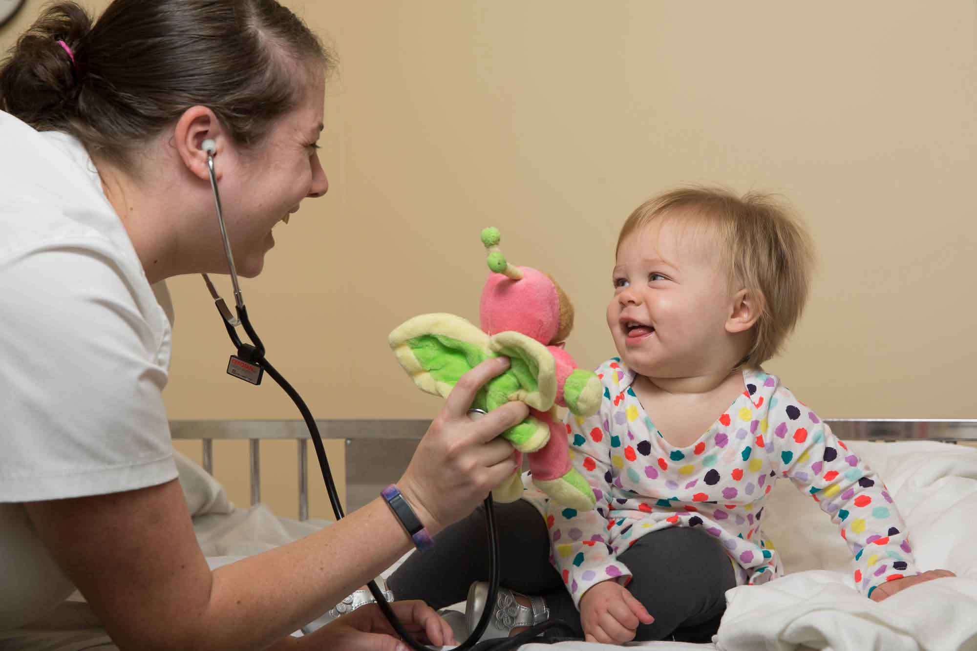 A nursing student entertains a toddler